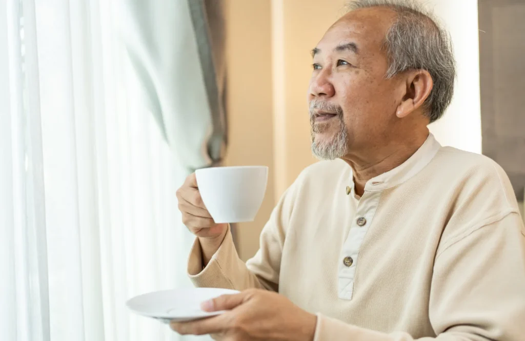 Senior asian man holding a tea cup.